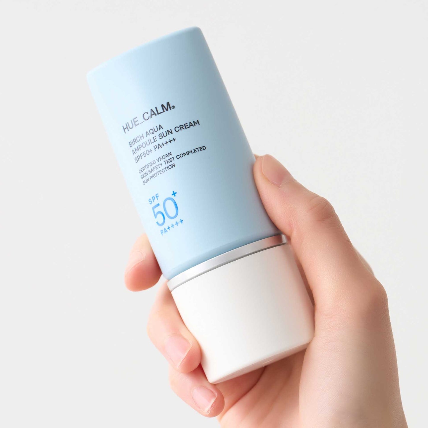 Hand holding Huecalm Birch Aqua Sun Cream SPF 50+ PA++++