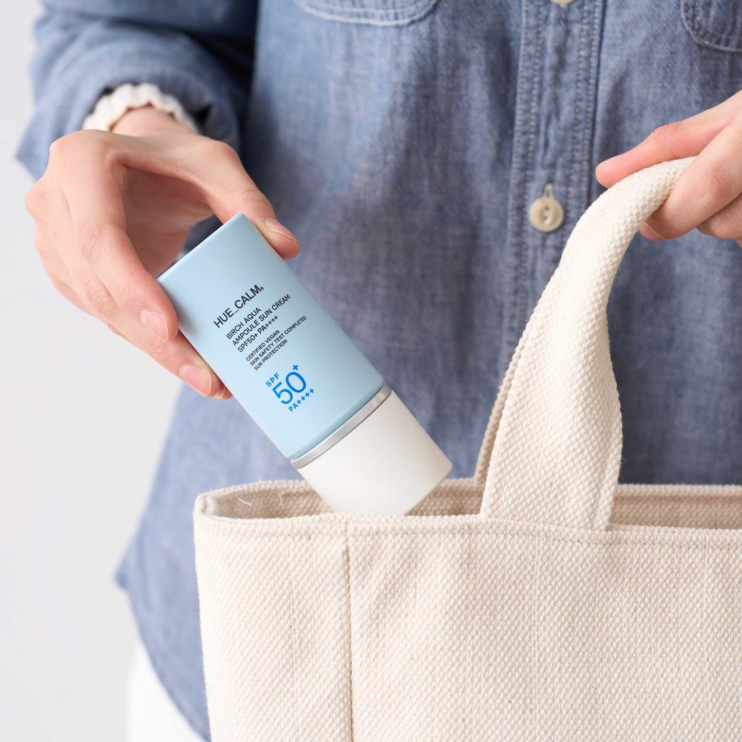 Huecalm Sun Cream portable size fitting into tote bag