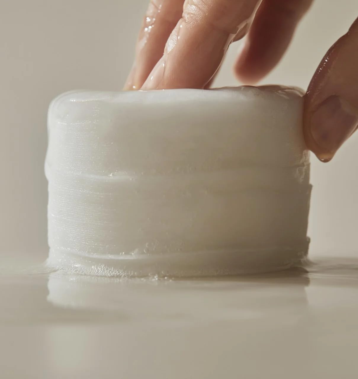 Huecalm - Close-up of stacked toner pads soaked in essence, showing moisture-rich texture and softness.