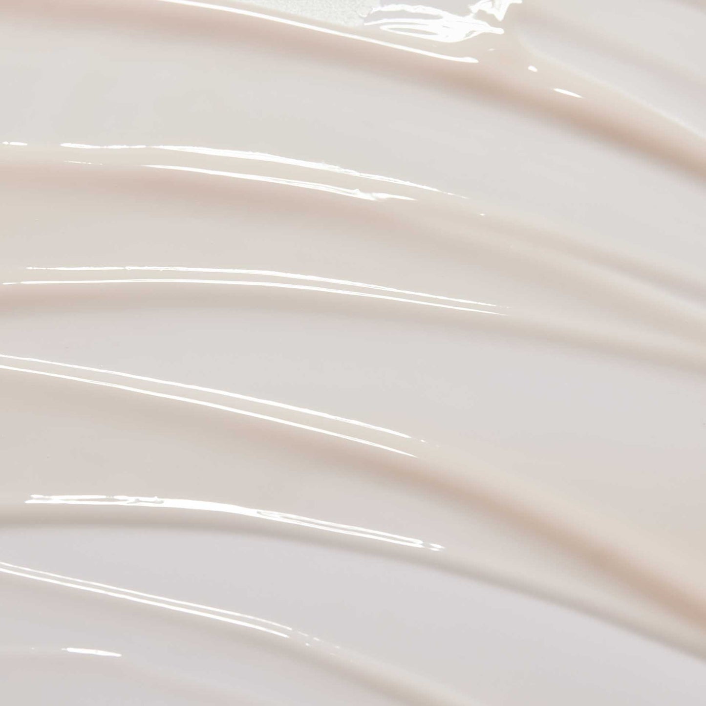 huecalm-Serum texture close-up – lightweight milky formula on swirled background