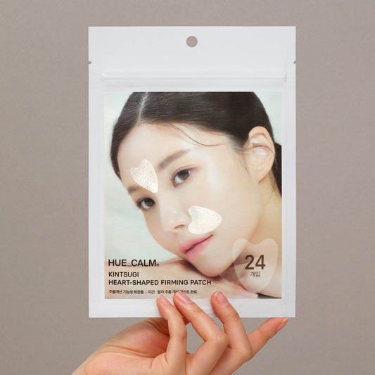 Hand holding Hue Calm Kintsugi Heart-Shaped Anti-Wrinkle Patch pouch – Korean vegan skincare packaging with heart-shaped lifting patches for face
