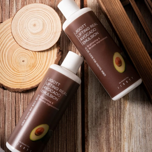 Two JIGOTT avocado emulsions styled on rustic wood background with natural props