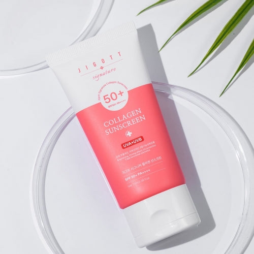 Jigott Collagen Sunscreen on transparent tray with green leaf props