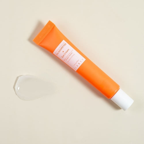 Jigott Eye Cream with visible gel texture next to the tube on cream background