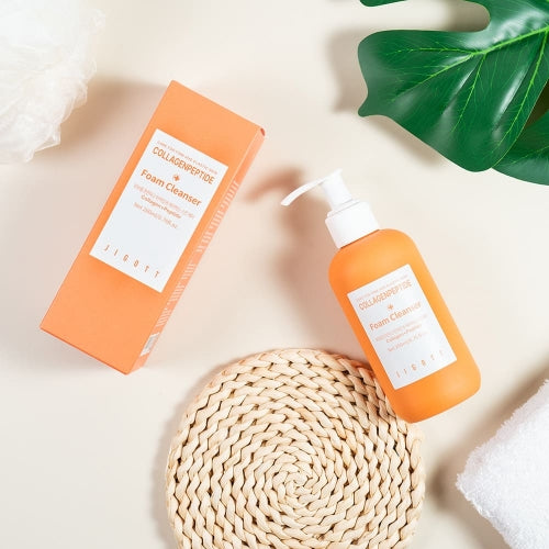 Jigott Collagenpeptide Foam Cleanser and box on flatlay with props for wholesale
