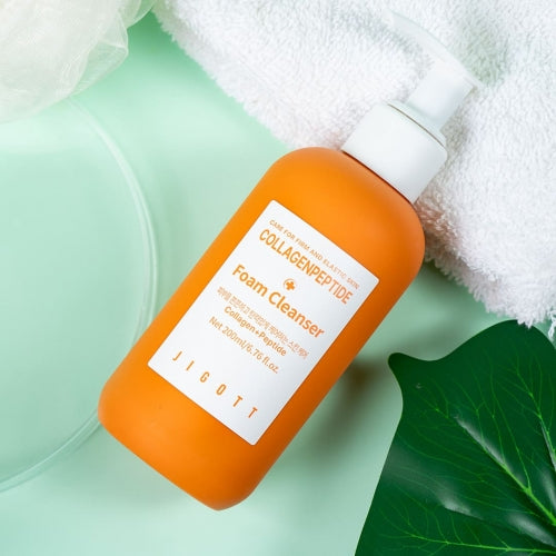 Jigott Collagenpeptide Foam Cleanser on towel flatlay for K-Beauty wholesale