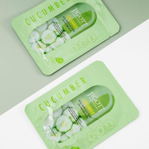 Two cucumber masks on clean split-color background for modern aesthetic