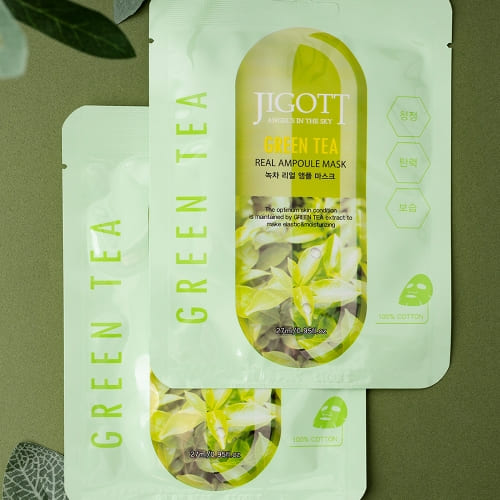 Green tea masks styled on dark green surface for elegant skincare promotion