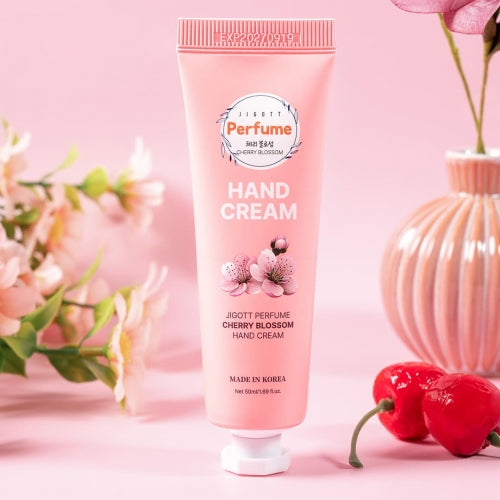 Cherry Blossom scented hand cream tube displayed with pink cherry flowers