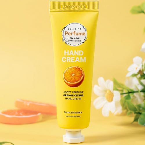 Orange Citrus hand cream tube shown with fresh citrus slices and yellow background