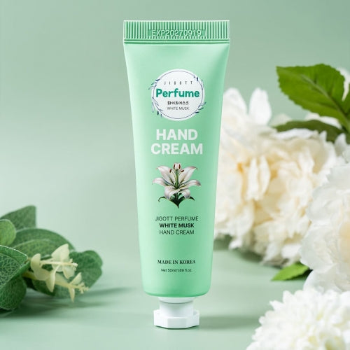 White Musk hand cream tube styled with white flowers and soft green tones