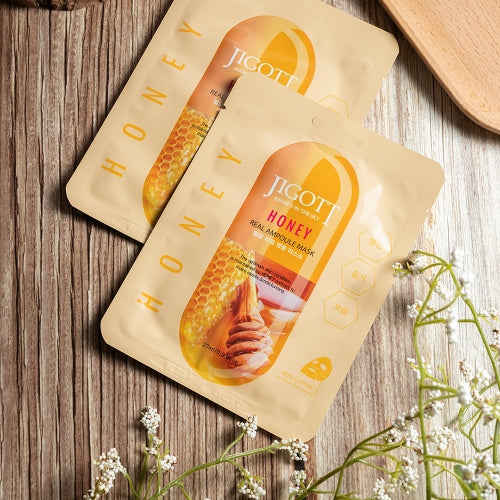 Two honey ampoule masks styled with flowers and wood background in flatlay view