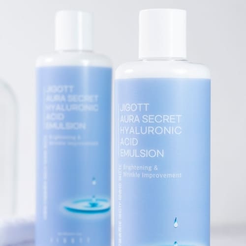 Close-up of two emulsion bottles with soft light highlighting clean skincare branding