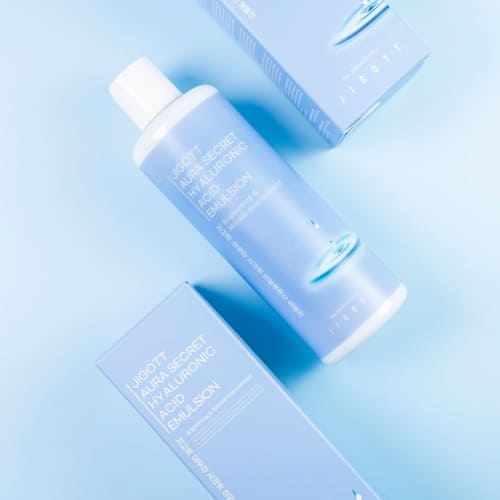 Top view of product and boxes arranged aesthetically on pastel blue background