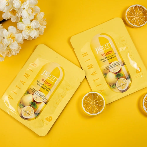 Dual mask flatlay with white flower blossoms and lemon on bold yellow background