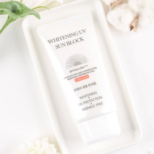 Jigott Whitening UV Sunscreen on white tray with cotton flower and greenery