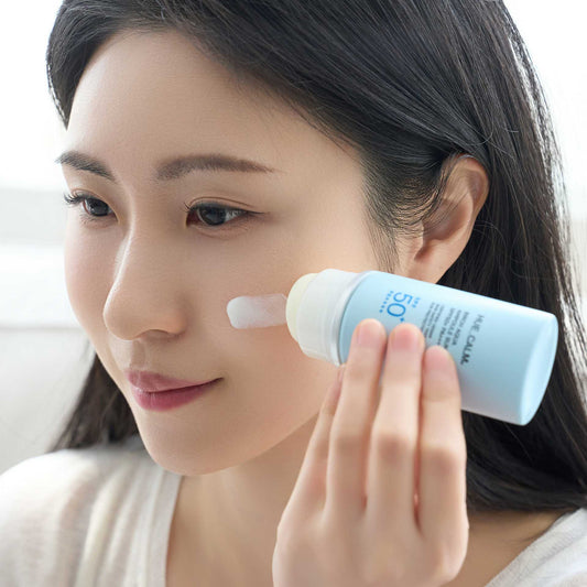 Huecalm Sun Cream applied to face by female model