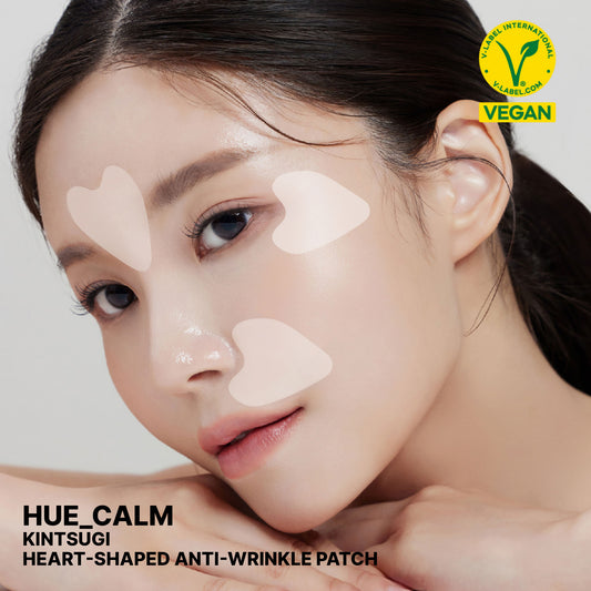 Woman wearing Hue Calm heart-shaped anti-wrinkle patches on forehead and cheeks – vegan Korean skincare for lifting and wrinkle care