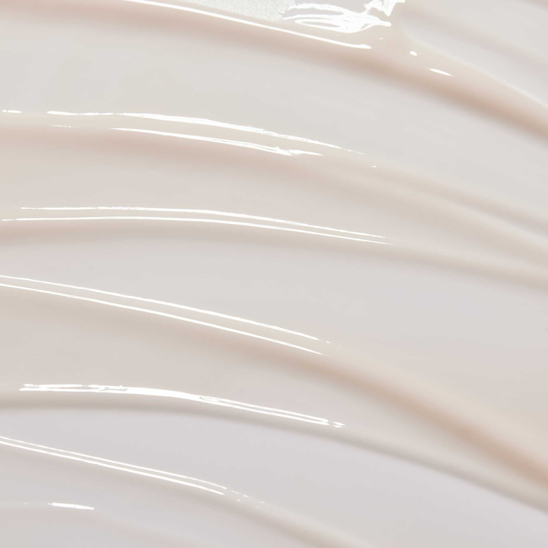huecalm-Serum texture close-up – lightweight milky formula on swirled background