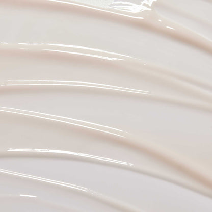 huecalm-Serum texture close-up – lightweight milky formula on swirled background