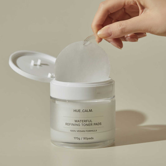 Huecalm - Picking up a single toner pad with tweezers from the Huecalm Waterful Refining Toner Pads jar.
