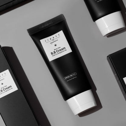 Jigott All-in-One BB Cream black tube flatlay with boxes on gray background