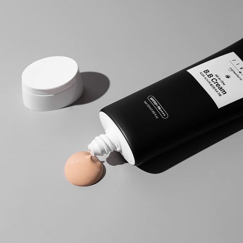 Jigott All-in-One BB Cream with beige cream squeezed out onto gray surface