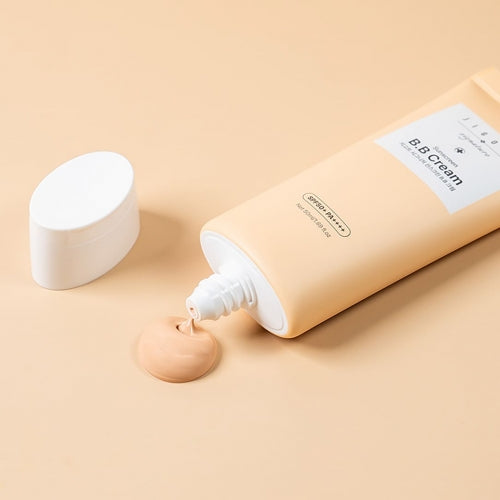 Jigott BB Cream Sunscreen with cream squeezed out on beige backdrop