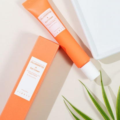 Angled top-down shot of Jigott Eye Cream and packaging on a cream-colored background