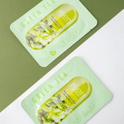 Two Jigott green tea masks laid flat on clean green and white background