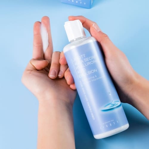 Model applying emulsion on hand showing lightweight hydrating texture