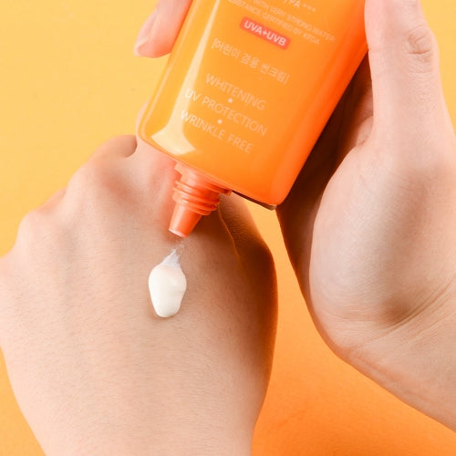 Jigott Snail UV Sunscreen being applied to back of hand showing white cream texture