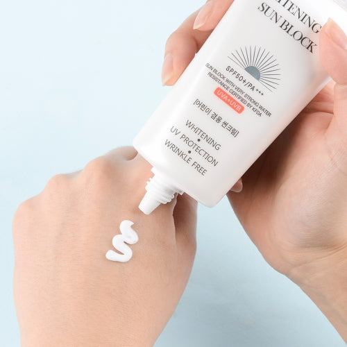 Jigott Whitening UV Sunscreen being applied to hand showing white cream texture