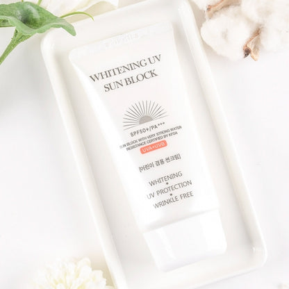 Jigott Whitening UV Sunscreen on white tray with cotton flower and greenery