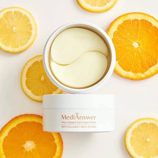 Open jar of Vita Collagen Eye Patches surrounded by lemon and orange slices highlighting vitamin formula